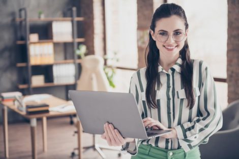smiling woman with laptop - marketing manager